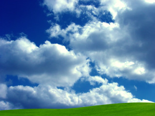 Green hill blue sky clouds 3 - a green field below free wallpaper