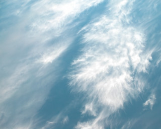 Plane flying cloudy sky ocean - the background and a plane in the foreground free wallpaper