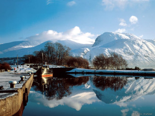 Boat docked harbor mountains snow - the ground in the foreground free wallpaper