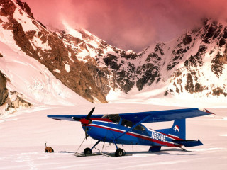 Blue airplane snowfield mountains orange - top of a snow free wallpaper