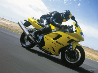 Man riding yellow motorcycle street 2 - a yellow motorcycle free wallpaper