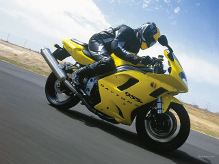 Man riding yellow motorcycle street 4 - a yellow motorcycle free wallpaper