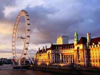Ferris wheel building river bank 2 - a cloudy sky in the background free wallpaper for desktop