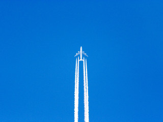 Jet flying blue sky trailing - free airplane wallpaper