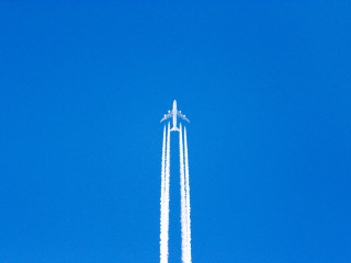 Jet flying blue sky trailing 2 - free airplane wallpaper