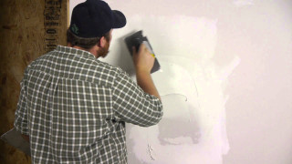 Man painting wall white paint - an ultrafine free wallpaper