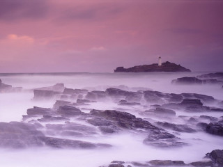 Lighthouse rocky shore pink sky 3 - a pink sky in the background free wallpaper