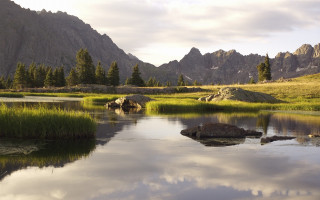 Mountain range lake rocks grass 2 - the water and grass free wallpaper