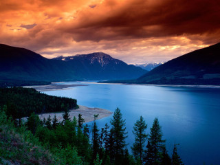 Lake mountains cloudy red sky - tree below free wallpaper