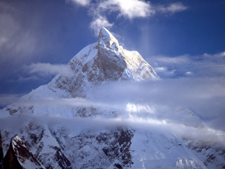 Snowy mountain cloudy sky sunbeam 3 - a sunbeam in the distance free wallpaper