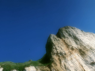 Rock formation bird blue sky 2 - a small patch of grass free wallpaper