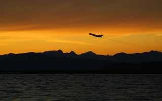 Plane flying water sunset mountains 2 - the background and a plane free wallpaper