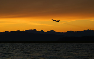 Plane flying water sunset mountains 4 - the background and a plane free wallpaper