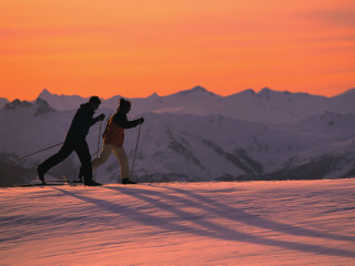 Two people skiing sunset snow 2 - ski free wallpaper