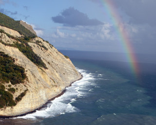 Rainbow ocean cliffs beach water - a beach below free wallpaper