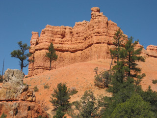 Rock formation trees blue sky - a large rock formation free wallpaper