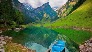 Boat docked lake mountains green - a lake in the foreground free wallpaper