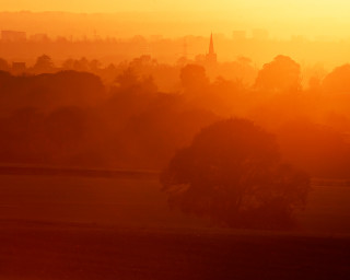 City sunset horse grazing foreground 2 - volumetric light free wallpaper