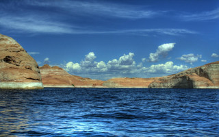 Lake sky clouds rocks beach - a rock formation in the background free wallpaper