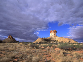 Large rock formation desert cloudy 3 - a large rock formation in the middle of a desert area free wallpaper
