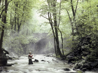 Man river fishing holding fish - a fish free wallpaper