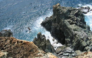 Rocky cliff water person swimming 2 - zenith view free wallpaper
