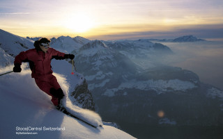 Man red snow suit skiing - a mountain side free wallpaper