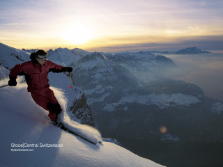 Person red snow suit skiing - a mountain side free wallpaper