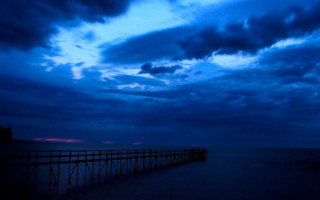 Long pier beach cloudy sky 2 - top of a beach under a cloudy sky free wallpaper
