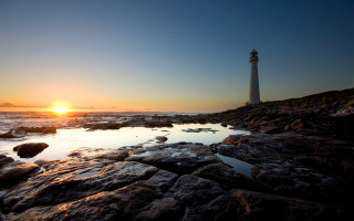 Lighthouse rocky shore sunset sun 3 - the background and the water free wallpaper