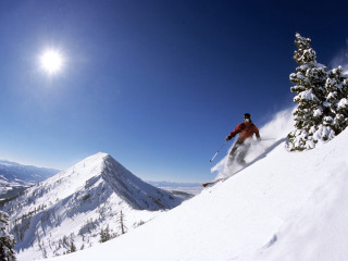 Skier skiing snowy mountain slope 2 - a skier free wallpaper