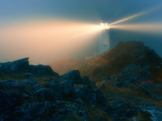 Lighthouse rocky cliff foggy sky - radiant free wallpaper