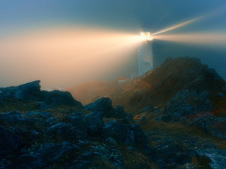 Lighthouse rocky cliff foggy sky 4 - radiant light free wallpaper for desktop
