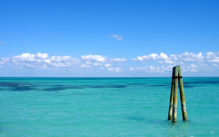 Wooden pole ocean sky clouds 3 - the ocean water free wallpaper