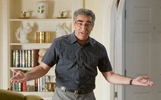 Man living room arms outstretched - a living room free wallpaper