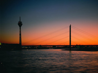 Sunset bridge tower water view 3 - a body of water in front free wallpaper