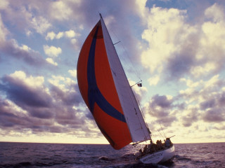 Sailboat red blue sail water - a sailboat free wallpaper