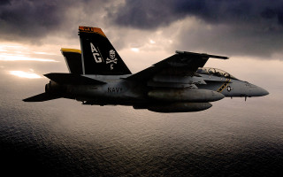 Fighter jet cloudy sky ocean - a dark cloud free wallpaper
