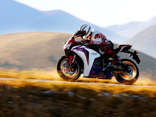 Motorcycle ride mountains grass sunny - motion blur free wallpaper