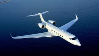 White jet flying ocean sky - a small island in the distance free wallpaper