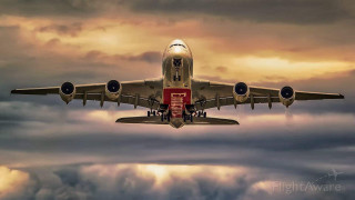 Jetliner flying cloudy sky red - a red stripe free wallpaper