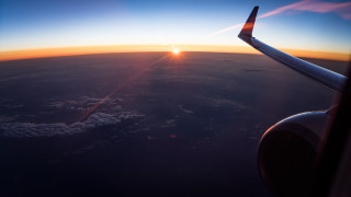 Sunset over clouds airplane wing - orange sun free wallpaper