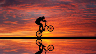 Man riding bike lake sunset - eric deschamps free wallpaper