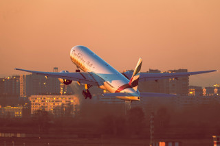Jetliner cloudy sky city sunset - golden free wallpaper