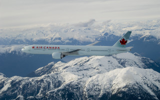 Canadian airplane flying mountain range - award free wallpaper