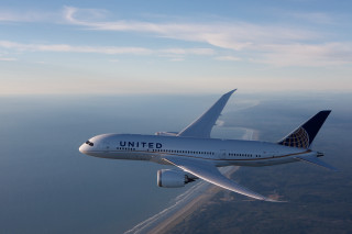 United airplane over ocean sunny - white cloud above free wallpaper