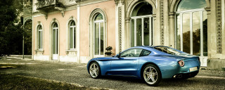 Blue sports car clocktower building - side and a person free wallpaper